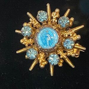 Gorgeous Vintage Virgin Mary brooch featuring a starburst design